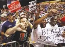  ?? CHRIS O’MEARA / AP ?? Supporters of President Donald Trump shout down a CNN news crew before a rally in Tampa, Fla. Amid the “Trump 2020” placards, the “Women for Trump” signs and other T-shirts, the most inscrutabl­e message that came out of Trump’s Tampa rally on Tuesday...