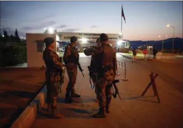  ?? AP PHOTO/EMRAH GUREL ?? Turkish security officials stand outside a courthouse before a convoy with US pastor Andrew Brunson sitting inside a car arrives for his trial in Izmir, Turkey, early.