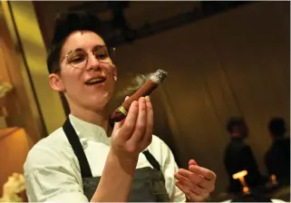  ?? Photo by VALERIE MACON / AFP ?? A pastry chef shows off a chocolate cigar during the 96th Oscars Governors Ball preview at the Ray Dolby Ballroom on March 5, 2024 in Hollywood, California.
