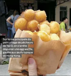  ??  ?? Sur la rue principale du petit village de pêcheurs de Tai O, on s’arrête déguster une egg waffle, gaufre aux oeufs typique de Hong Kong.