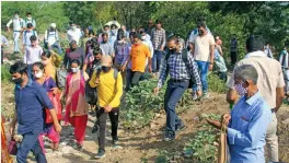  ?? — PTI ?? Factory workers walk through a forested area in an attempt to cross the DelhiGurug­ram border on Monday.