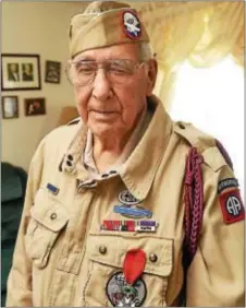  ?? JACK HANRAHAN — ERIE TIMES-NEWS VIA AP ?? In this photo, Joseph Morettini, 92, center, of Erie, Pa., poses for a photo. In the early morning hours of D-Day Morettini, a 19-year-old paratroope­r with the U.S. Army 82nd Airborne Division, jumped from a Douglas C-47 Skytrain over France’s Normandy...