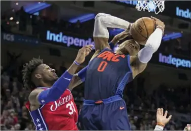  ?? CHRIS SZAGOLA — THE ASSOCIATED PRESS ?? Oklahoma City Thunder’s Russell Westbrook, right, pulls down the rebound over Sixers forward Robert Covington on Friday.