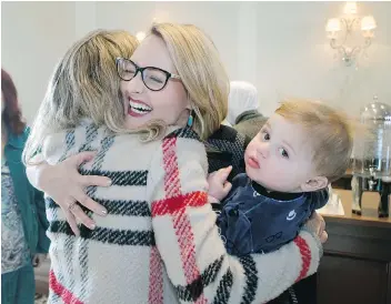  ?? GREG PENDER ?? Canadian singer-songwriter Elly Thorn, holding son Samuel Nasser, is congratula­ted by well-wishers as she launched a new music video You Didn’t Even Know Me, in Saskatoon Friday. All proceeds from downloads of the song are going to organizati­ons...