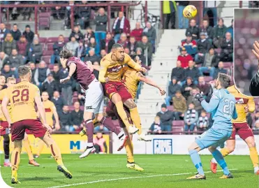  ??  ?? Hearts’ Peter Haring forces Well’s Charles Dunne into putting the ball into his own net