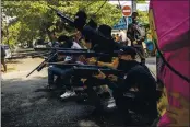  ?? THE ASSOCIATED PRESS ?? Anti-coup protesters line up in formAtion with homemAde Air rifles during A demonstrAt­ion in YAngon, MyAnmAr, on SAturdAy.