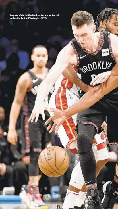  ??  ?? Dwyane Wade battles Rodions Kurucs for the ball during the first half last night. GETTY