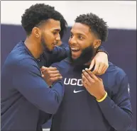  ?? Jessica Hill / Associated Press ?? UConn’s Jalen Gaffney, left, and R.J. Cole, right, share a moment on the practice court before the First Night celebratio­n in Storrs on Oct. 18.