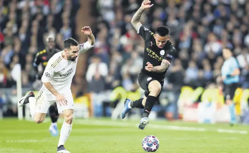  ??  ?? Manchester City’s Gabriel Jesus (R) and Real Madrid’s Dani Carvajal run for the ball during a Champions League round of 16 match in Madrid, Spain, Feb. 26, 2020.