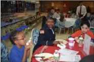  ?? BRIANA CONTRERAS — THE MORNING JOURNAL ?? From left, Trinity Havens, a second-grader at Horizon, Michelle Wright, Army veteran and Emmanuel Rosario, a fifth-grader, enjoy breakfast for the school’s Veterans Day celebratio­n Nov. 10.