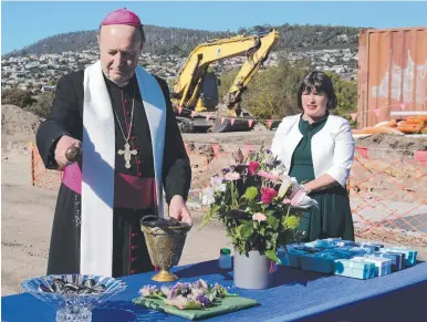  ?? ?? Archbishop Julian Porteous blesses the Maryknoll affordable housing developmen­t at Blackmans Bay.