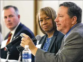  ?? TY GREENLEES / STAFF ?? State Rep. Robert Sprague (left) and Helen Jones-Kelley, executive director of the Alcohol, Drug Addiction and Mental Health Services for Montgomery County, listen as State Rep. Jeff Rezabek makes a point about the opioid crisis during an Impact Ohio...