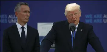  ?? PHOTO/EVAN ?? NATO Secretary General Jens Stoltenber­g listens as President Donald Trump speaks during a ceremony to unveil artifacts from the World Trade Center and Berlin Wall for the new NATO headquarte­rs Thursday in Brussels. AP
VUCCI