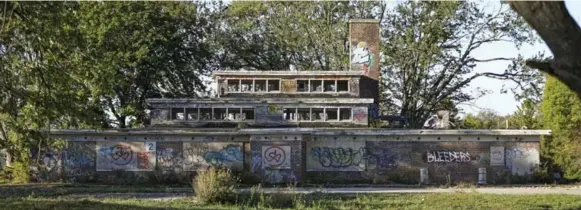  ?? RANDY RISLING PHOTOS/TORONTO STAR ?? The former site of Pine Ridge, which opened in 1925 as the Bowmanvill­e Boys’ Training School, now sits derelict. Steven Greenwood, left, tours the site. Below is the solitary cell where he says he spent days.