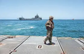  ?? AMIR COHEN/REUTERS FILE ?? A soldier stands at Trident Pier, a temporary pier to deliver aid, near the Gaza coast on June 25.