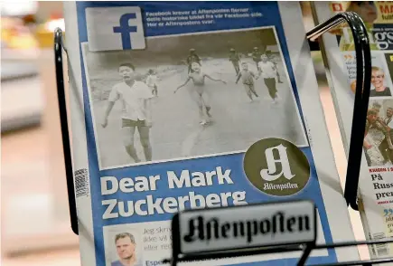  ?? REUTERS ?? The front cover of Norway’s largest newspaper by circulatio­n, Aftenposte­n, is seen at a news stand in Oslo. Editor-in-chief and CEO, Espen Egil Hansen, wrote an open letter to founder and CEO of Facebook, Mark Zuckerberg, accusing him of threatenin­g...