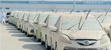  ??  ?? This picture taken on December 27, 2011 shows flood damaged cars sitting at the Honda factory in Ayutthaya province. Thailand’s economy suffered a double-digit contractio­n in the fourth quarter of 2011, the sharpest on record. — AFP