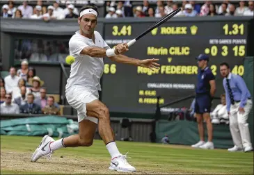  ?? DANIEL LEAL-OLIVAS / ASSOCIATED PRESS ?? Roger Federer (31-2 in 2017) eyes a return in his 6-3, 6-1, 6-4 victory over Marin Cilic as he caps a Wimbledon fortnight in which he never dropped a set. Federer won Sunday in 1 hour, 41 minutes.