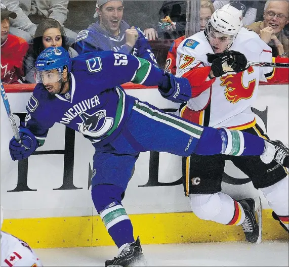  ?? STEVE BOSCH — PNG FILES ?? Prab Rai makes a big hit on Lance Bouma of the Calgary Flames in a preseason game at Rogers Arena in September 2010. At the time, the Canucks’ 2008 fifth-round pick was getting temporary relief for back pain following a car accident in June that year.
