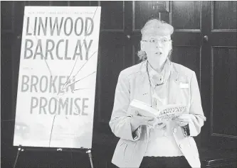  ?? DAVID BEBEE WATERLOO REGION RECORD ?? Kitchener Public Library librarian Mary Monteith reads from the Linwood Barclay novel “Broken Promise” on Thursday. The book was unveiled as the One Book, One Community choice this year.