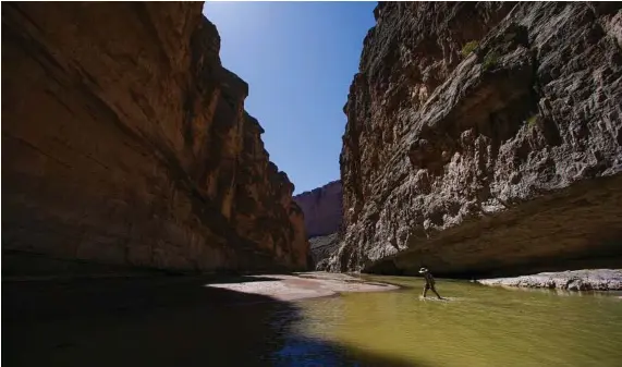  ?? Michael Ciaglo / Houston Chronicle ?? A hiker travels up Santa Elena Canyon through the Rio Grande in Big Bend National Park. The park covers 800,000 acres.