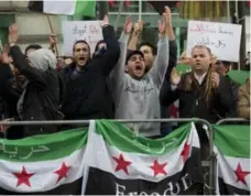  ?? JOE KLAMAR/AFP/GETTY IMAGES ?? Protesters gather in front of the Hotel Imperial in Vienna, Austria, where diplomats are discussing ways to resolve the conflict in Syria.