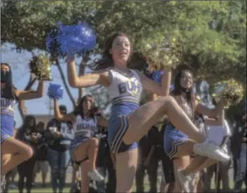  ?? PHOTOS BY VINCENT OSUNA ?? RIGHT: Cidney Roper cheers with her fellow Brawley Union High cheerleade­rs during a community Bell Game rally on Wednesday in Brawley.