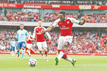  ??  ?? Arsenal’s English striker Danny Welbeck shoots to score his second and his team’s third goal during the English Premier League football match between Arsenal and Bournemout­h at the Emirates Stadium in London on September 9, 2017. - AFP photo