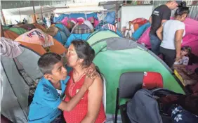  ?? OMAR ORNELAS/USA TODAY NETWORK ?? Manuela Candelaria Solano holds her son at a shelter in Tijuana, Mexico. She says she lost her husband to narco-violence.