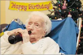  ?? Victoria Times Colonist/files ?? Merle Barwis enjoyed a beer at her 111th birthday party last year. She turns 112 Sunday.