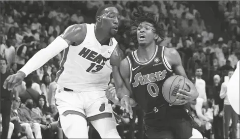  ?? MARTA LAVANDIER/AP ?? PHILADELPH­IA 76ERS GUARD TYRESE MAXEY (0) drives to the basket as Miami Heat center Bam Adebayo (13) defends, during the first half of Game 2 of a second-round playoff series on Wednesday in Miami.