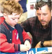  ??  ?? Chris Early helps his son Harlan on his first day at Bunyip Primary School.