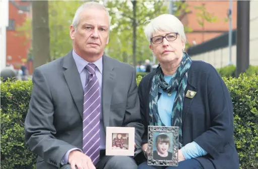  ??  ?? Grieving: Alan and Jennifer Roberts with photograph­s of their daughter Claire outside Laganside Courts during the inquest into her death held last year