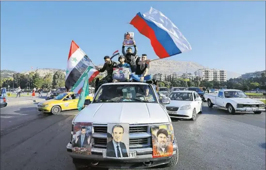  ?? Hassan Ammar Associated Press ?? IN DAMASCUS, hundreds demonstrat­ed their support for President Bashar Assad after the missile strikes, waving Syrian, Iranian and Russian f lags.