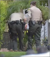  ?? Dan Watson/The Signal ?? Sheriff’s Station deputies search for evidence outside, above, and in the garage, right, of a residence on Bracken Lane in Stevenson Ranch on Saturday, following reports of an armed robbery and shooting.