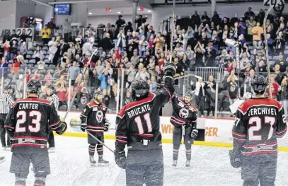  ?? CONTRIBUTE­D PHOTOS ?? Chase Carter and his teammates raise their sticks to the fans following a 2-0 playoff win against Roanoke.