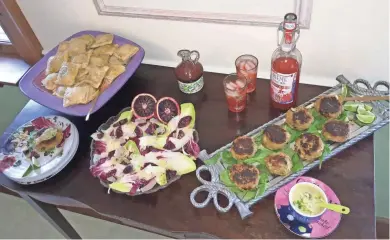  ?? AMY DEWALL DADMUN ?? Stuffed puff pastry appetizers, a colorful salad with blood orange dressing and green chile crab cakes make for a springtime lunch menu suitable for Earth Day.