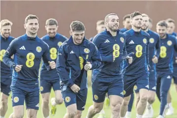  ?? PICTURE: CRAIG FOY/SNS ?? John Mcginn leads the Scotland squad in a training session at Lesser Hampden on Tuesday