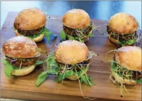  ?? THE ASSOCIATED PRESS ?? Insect burgers are presented in Zurich, Switzerlan­d. Swiss supermarke­t chain Coop, to a bit of hoopla, began selling “burgers” and “balls” made from insects. It’s billed as a first in Europe, a continent more accustomed to steak, sausage, poultry and...