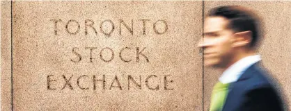  ?? REUTERS/MARK BLINCH ?? A man walks past an old Toronto Stock Exchange (TSX) sign in Toronto, June 23, 2014.