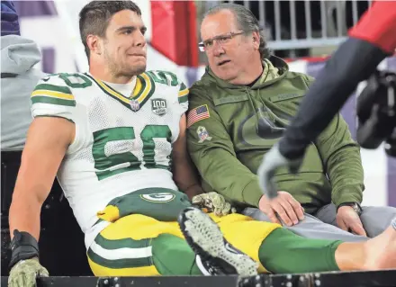  ?? MARK HOFFMAN / JOURNAL SENTINEL ?? Blake Martinez is carted from the field after injuring his left ankle on Sunday night.
