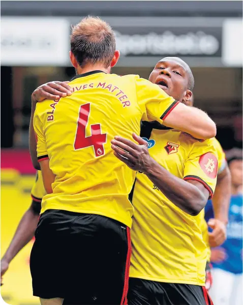  ??  ?? Watford’s Craig Dawson (No.4) takes the plaudits after scoring a late, late equaliser at Vicarage Road yesterday