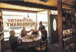  ?? Genaro Molina Los Angeles Times ?? WAITRESS Karissa Medina serves a customer on the first day that Granny’s Pantry Restaurant reopened to the public in Atwater, Calif., in late May.