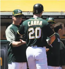  ?? Thearon W. Henderson / Getty Images ?? Bob Melvin, shown congratula­ting Mark Canha after Canha scored in the sixth inning, earned win No. 601 as A’s manager.