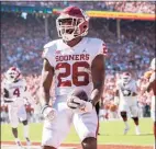  ?? Jeffrey McWhorter / Associated Press ?? Oklahoma running back Kennedy Brooks runs in for a touchdown against Texas during the fourth quarter Saturday at the Cotton Bowl in Dallas.