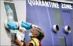  ?? PTI ?? A healthcare worker collects a swab sample, in Vijayawada, on Tuesday