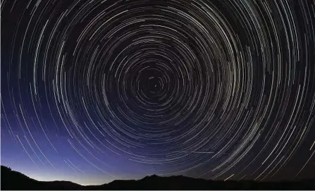  ?? Dani POZO/AFP / Getty Images ?? The meteor shower is caused by the Earth’s passing through the debris left behind from a comet known as Swift-tuttle.