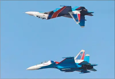  ?? AGENCE FRANCE-PRESSE ?? Two Sukhoi Su-30SM from the Russian Knights aerobatic team perform during the Dubai Airshow on Sunday.