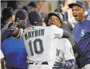  ?? Elaine Thompson / Associated Press ?? Seattle’s Robinson Cano is hugged by Cameron Maybin after hitting a three-run homer.