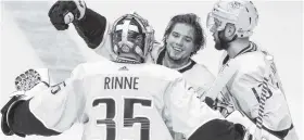  ?? THE ASSOCIATED PRESS ?? Nashville’s Kevin Fiala, center, celebrates with goalie Pekka Rinne (35) after Fiala scored the winning goal against the Winnipeg Jets on Sunday in Nashville.